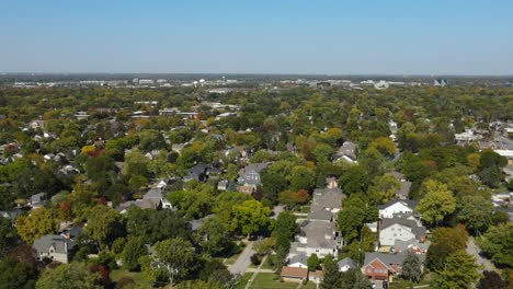aerial view of naperville, il suburb, showing autumn foliage and suburban neighborhood layout. crane down zoom day n