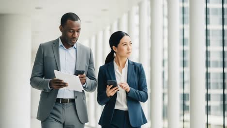 a professional duo engaging in digital communication: two colleagues collaborating in a modern office environment with technology and professionalism