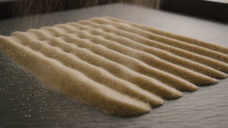 sprinkling brown sugar on a textured surface
