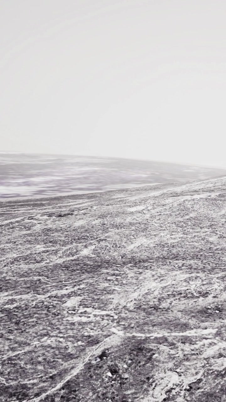 Wide view of a barren landscape with clouds and distant horizon