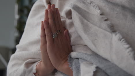 a meditating woman holding her hands together