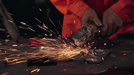 Professional-mechanic-is-cutting-steel-metal.