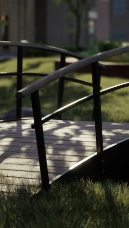 a wooden bridge over a small stream in a park