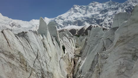 Drone-shot-of-flying-through-the-glacier-canyons-with-Nanga-Parbat-in-the-background,-Fairy-Meadows-Pakistan,-cinematic-aerial-shot