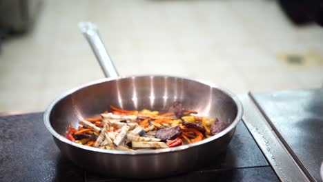 chef stir-frying vegetables