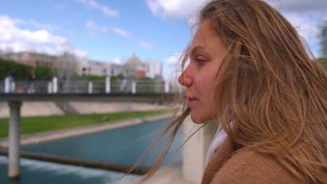 Slow-motion-footage-of-a-blond-girl-looking-the-river-in-Montpellier,-France