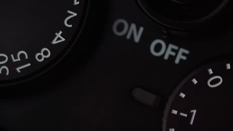 extreme macro of settings mechanism on mirrorless or dslr camera. rotation of exposure compensation wheel. retro vintage style.