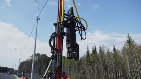 pile driver operation on a highway construction site