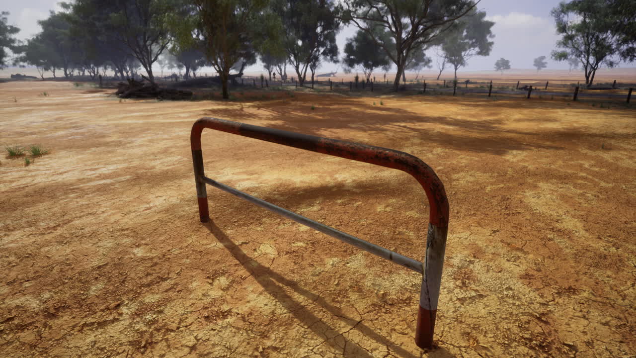 Rusty barrier stands in an arid landscape under a cloudy sky