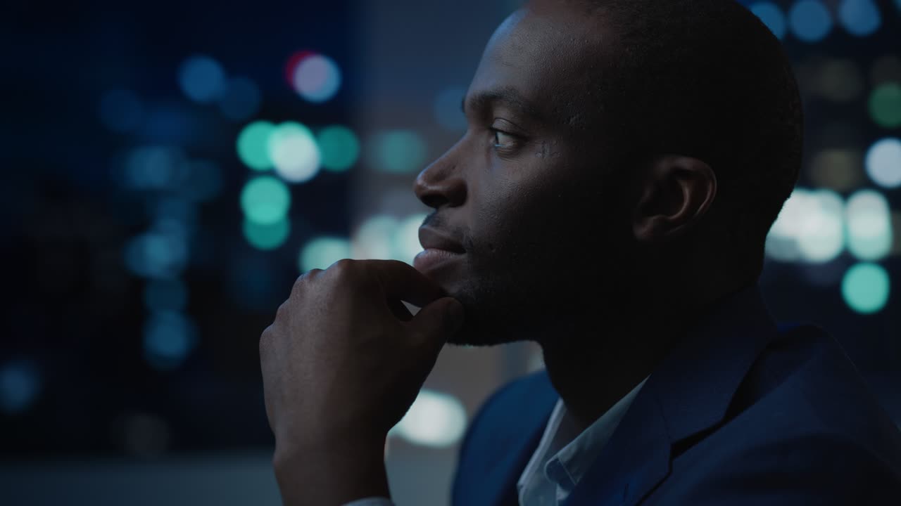 Portrait of a Financial Project Manager Working on Computer in an Office Late in the Evening. African American Businessman at Work in Investment Broker Agency.