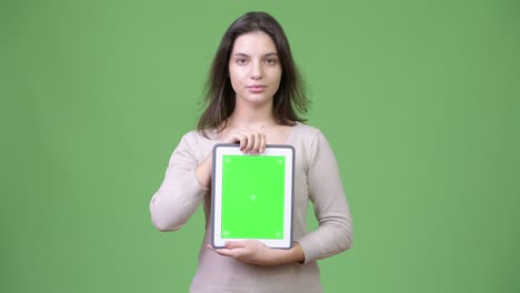 young beautiful woman showing digital tablet