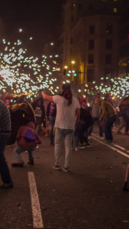 barcelona, spain - 22 september 2023 : crowds in the street for the fire run or correfoc, during la merce festival, barcelona spain in vertical