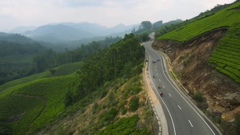 aerial drone shot of munnar’s sweeping views of tea estates and mountainous terrain