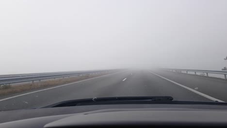 cars driving and speeding on foggy asphalt highway - pov, wide shot