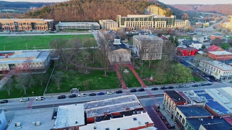 cars lined up in front of old state capitol building in downtown frankfort kentucky, aerial drone tilt downward shot