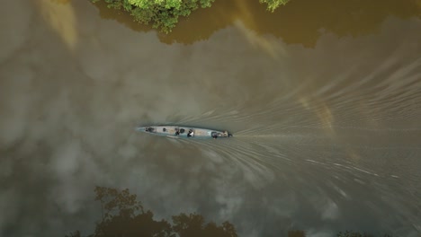 4k aerial top shot of ship sailing in the river of amazon forest