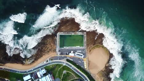 pool by the ocean drone shot looking down - newcastle australia