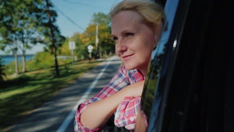 woman looking out car window