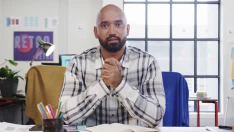 retrato de un diseñador masculino biracial en una videollamada en la computadora en una oficina casual, cámara lenta