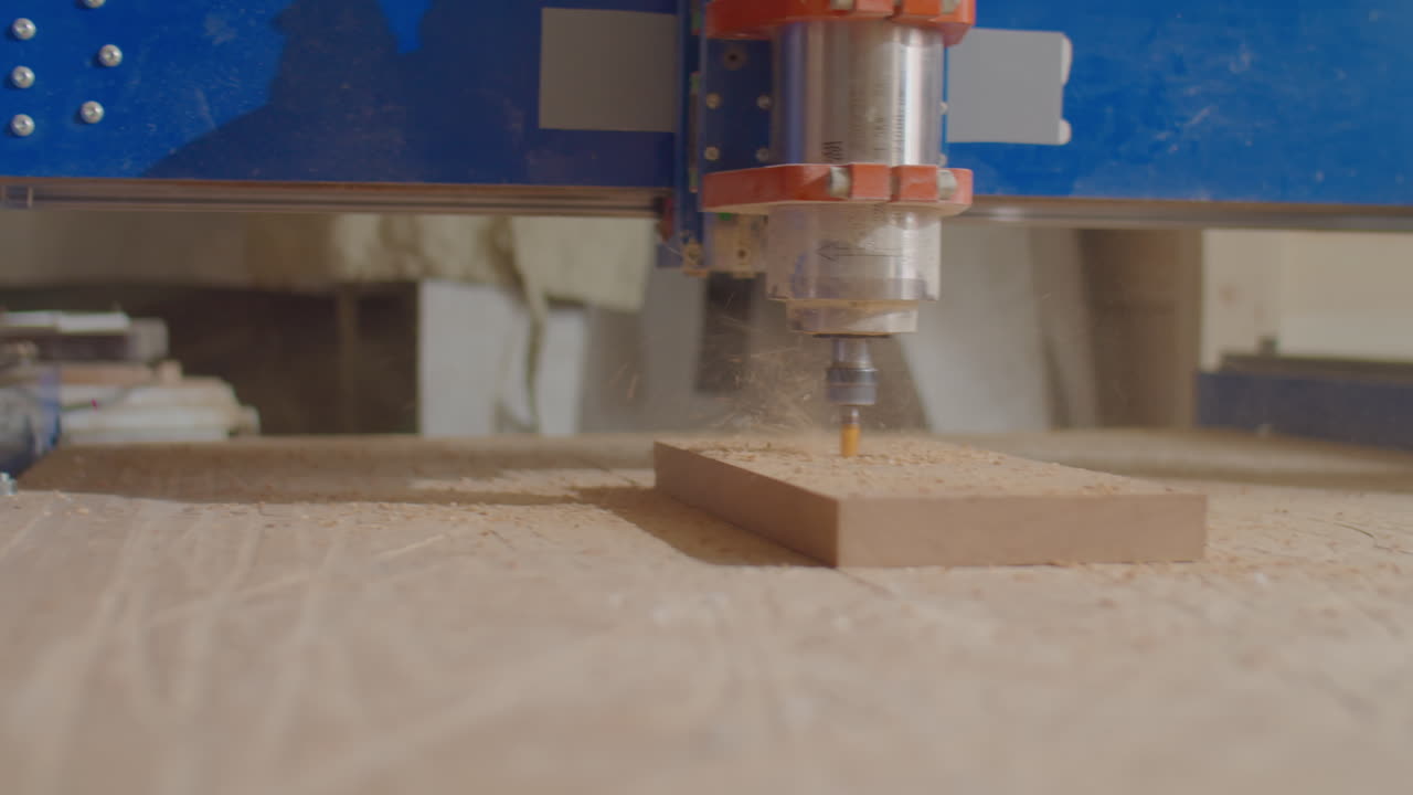 Woodworker Looking at Working CNC Machine