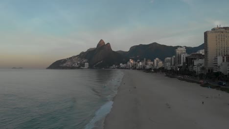 Aerial-panorama-from-the-Two-Brothers-mountain-revealing-the-empty-early-morning-beach-of-Ipanema-ending-up-showing-the-city-lake-and-Corcovado-mountain-in-Rio-de-Janeiro-at-sunrise