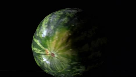 watermelon spinning on a table, black background