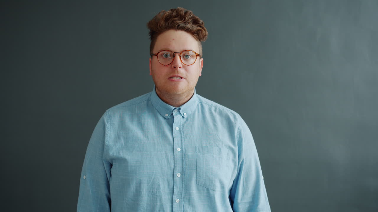 Man with Glasses and Light Blue Shirt