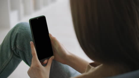 woman checks possible symptoms with professional physician using online video chat. young girl sick at home using smartphone to talk to her doctor via video conference medical app.