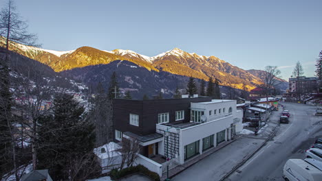 sunset that draws like a dark blanket over the austrian spa and ski town of bad gastein and the mountains behind it