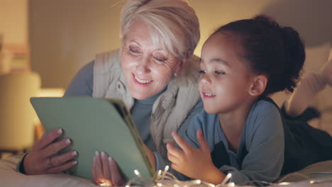 grandmother, child and tablet on bed