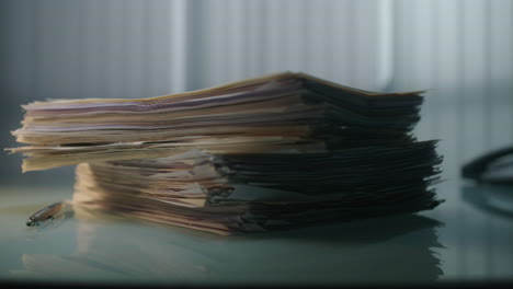 hand sorting a stack of papers on a desk