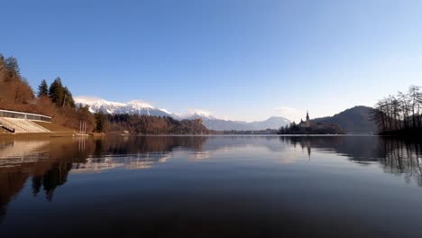 Slovenia,-Lake-Bled-with-the-church-and-the-snowy-Alps-in-the-background