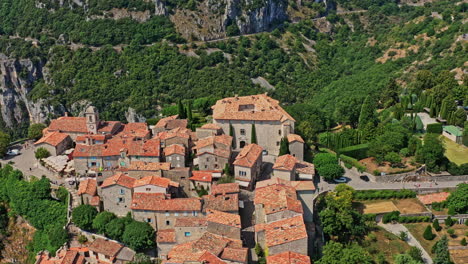 gourdon france aerial v3 cinematic establishing shot birds eye view drone fly around hilltop medieval town village with historic remains stone wall buildings - july 2021