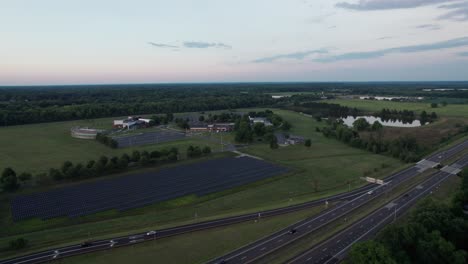 Drone-hovering-over-a-busy-highway-with-numerous-buildings-visible-nearby-and-a-sideways-which-has-inbuilt-solar-panel