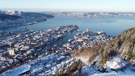 aerial backwards through mount floyen with bergen city view as background