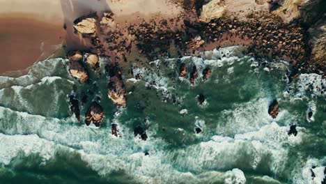 aerial view of a rocky beach and waves