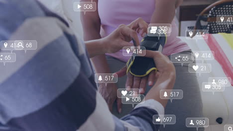 Animation-Von-Social-Media-Engagement-Symbolen-über-Personen,-Die-Den-Fitness-Tracker-Anpassen