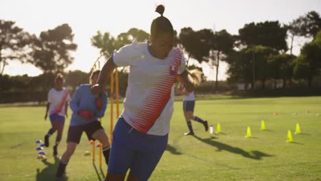 female soccer players doing exercises with equipment. 4k