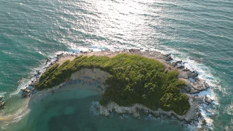 Drone-dolley-shot-over-Isole-Gemelle-in-the-Albanian-Riviera-on-a-windy-and-sunny-day