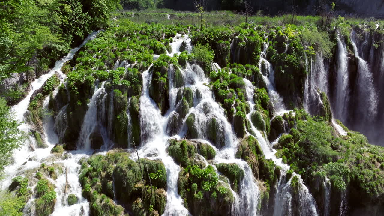 Waterfalls And Mossy Cliffs At Plitvice Lakes National Park In Croatia. - aerial ascend shot