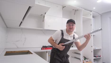 kitchen renovation with a carpenter installing cabinets