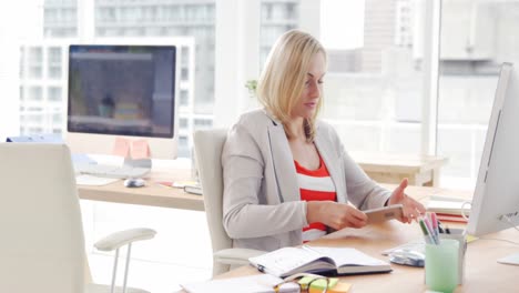 businesswoman talking on the mobile phone at her desk
