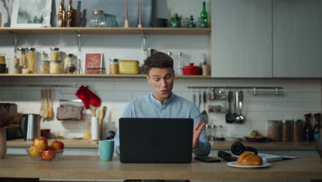 teacher starting online lesson for students using laptop at home kitchen.