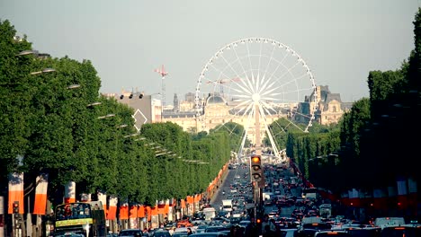 heavy traffic at avenue des champs-elysees leading up to the grande roue (big wheel) in paris, france