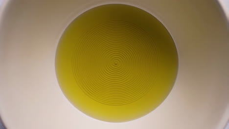 olive oil in a white bowl with circular ripples