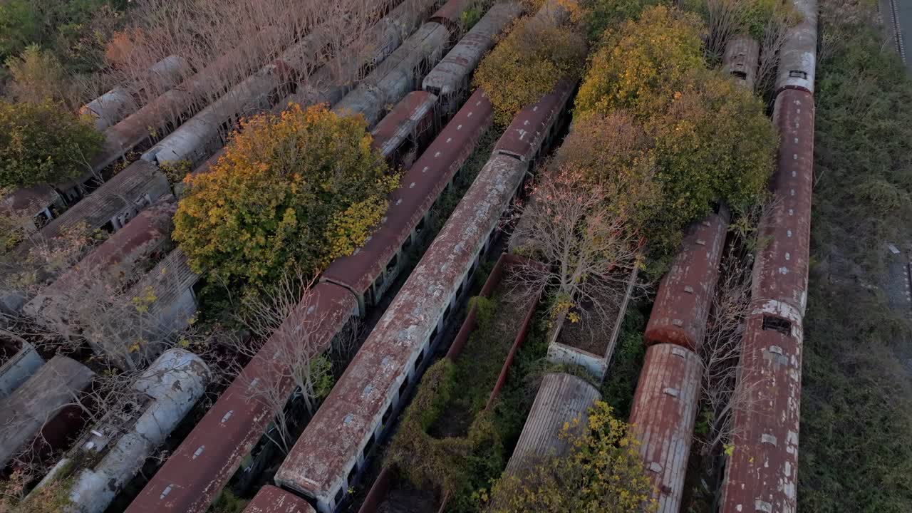 Abandoned locomotives and tracks in golden sunset light, Thessaloniki