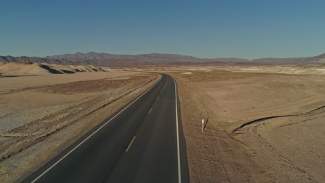 low aerial view along an empty highway in the desert