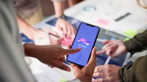 people using smartphone in a meeting