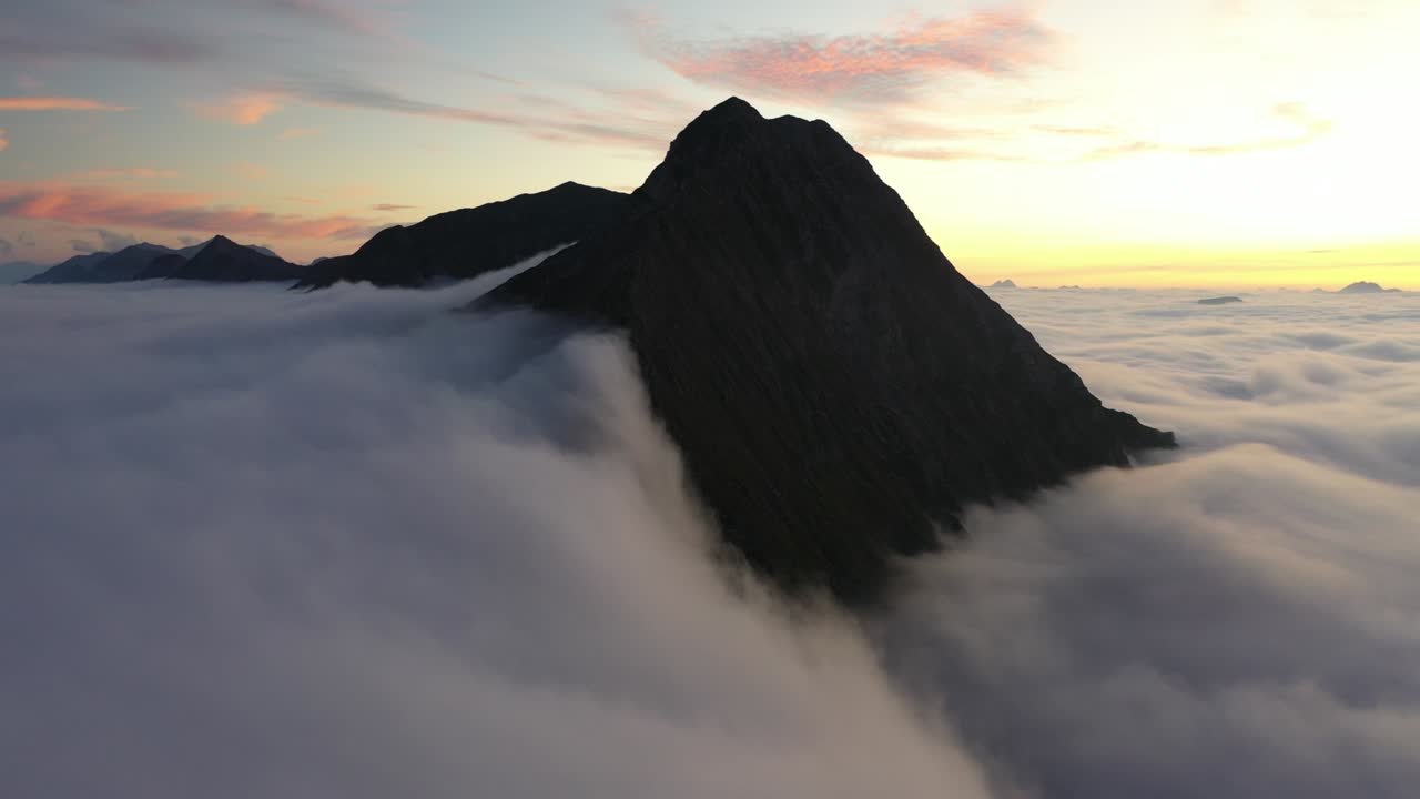 Drone shot of the top of Mount Niesen in Switzerland with beautiful and magical clouds moving and dancing around