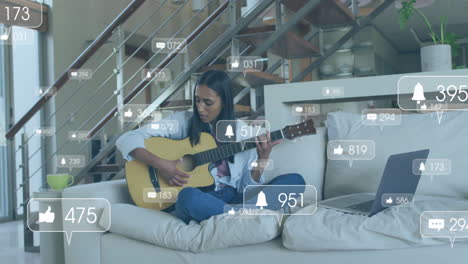 animation of icons and data processing over biracial woman playing guitar